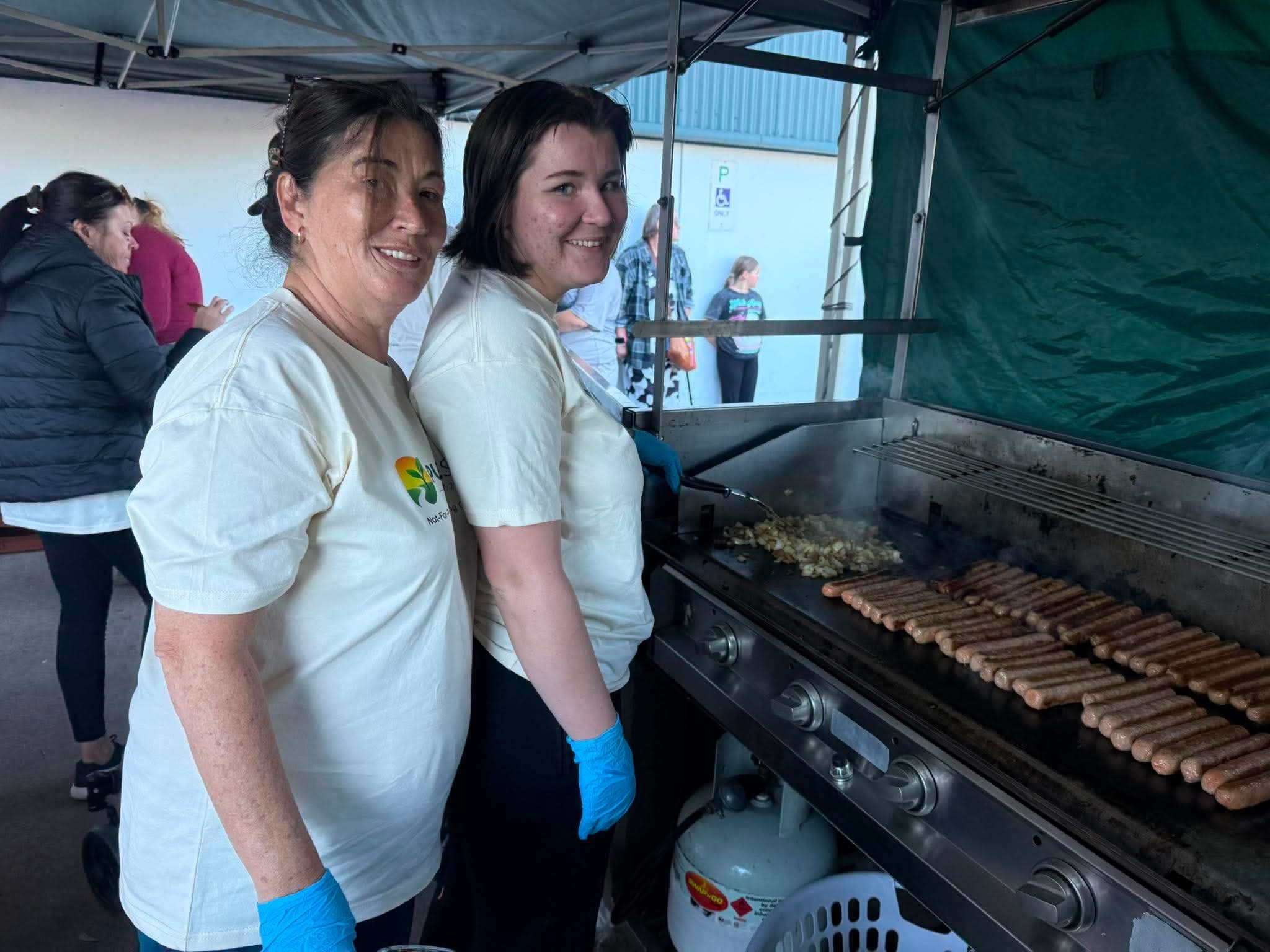 Two volunteers at the Bunnings sausage sizzle